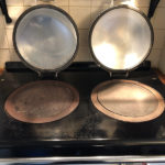 Aga hob with the left plate dull and stained and the right plate cleaned and polished