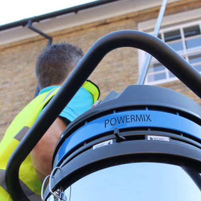 Close-up of a SkyVac Powermix gutter vacuum unit in use