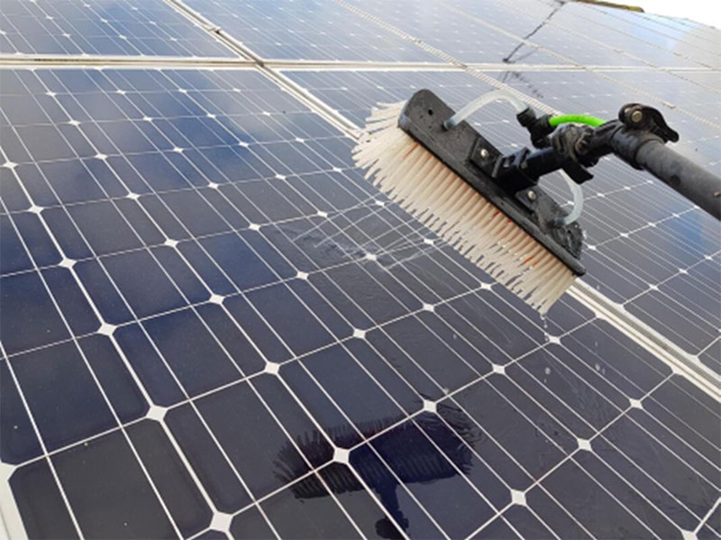 Using gentle brush to clean solar panels